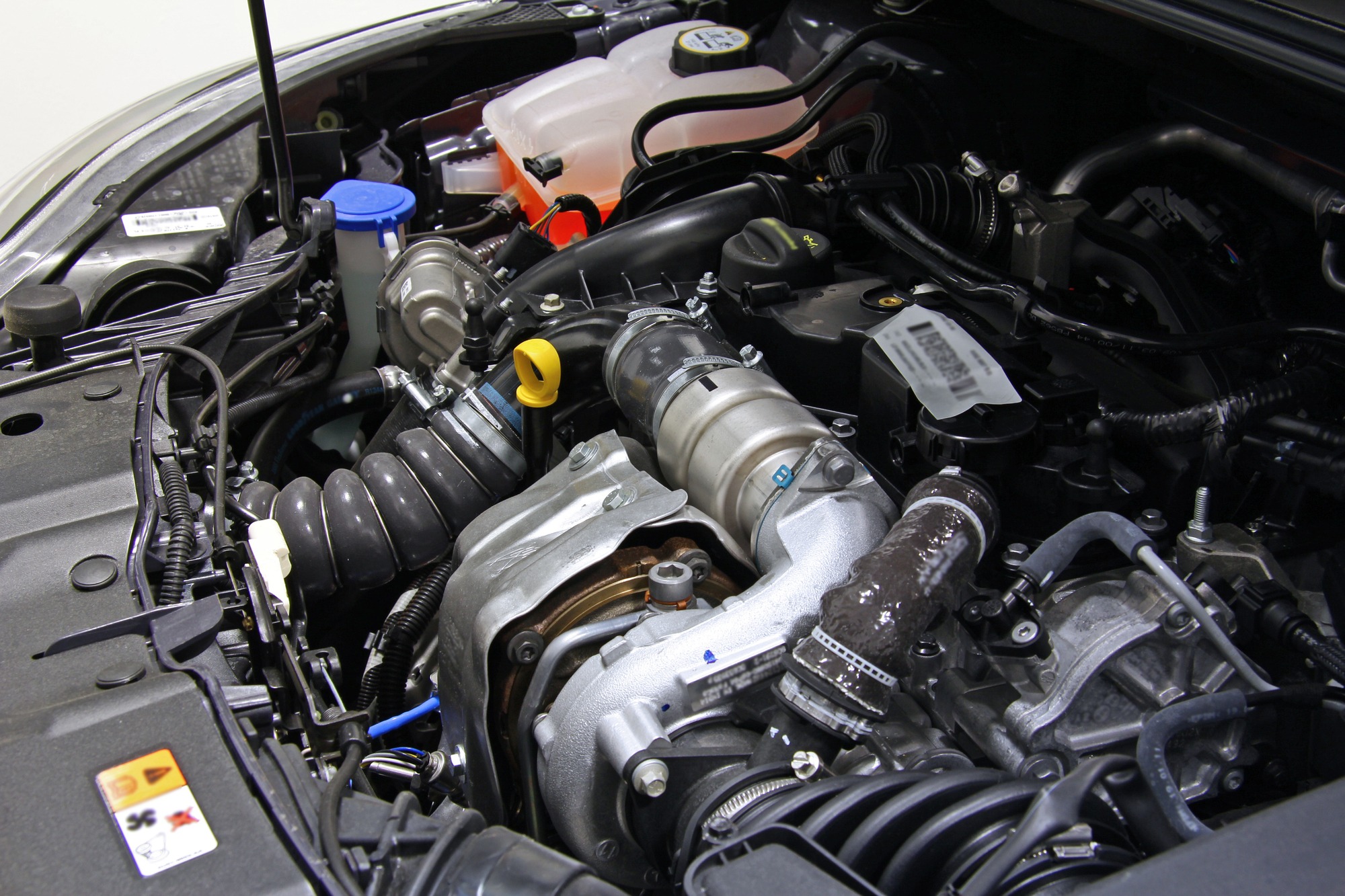 Open car hood with visible engine and interior